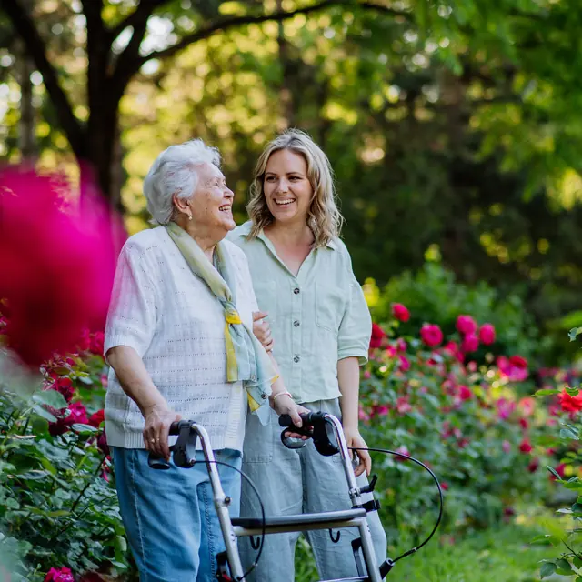 Senior woman laughing with her caregiver